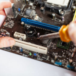 Technological background with closeup on tester checking motherboard. Toned image. Shallow DOF